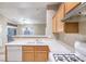Open concept kitchen features bright countertops, wood cabinets, and stainless gas range at 3351 Indian Shadow St # 204, Las Vegas, NV 89129
