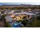 Stunning aerial view of a modern home with a pool, jacuzzi, and mountain views at 3452 Spanish Winds Ct, Las Vegas, NV 89141