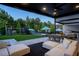 Spacious backyard with outdoor dining area, lounge seating, and recreational playground at 3452 Spanish Winds Ct, Las Vegas, NV 89141