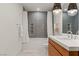 Contemporary bathroom featuring a floating vanity, sleek fixtures, and stylish gray subway tile in the shower at 3452 Spanish Winds Ct, Las Vegas, NV 89141