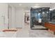 Stylish bathroom with a glass-enclosed shower, a soaking tub, and access to a walk-in closet at 3452 Spanish Winds Ct, Las Vegas, NV 89141