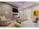 Modern bedroom design with patterned wallpaper, a cozy chair and built-in fish tank at 3452 Spanish Winds Ct, Las Vegas, NV 89141