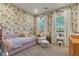 Inviting bedroom featuring unique wallpaper, natural light, and stylish furnishings for a cheerful retreat at 3452 Spanish Winds Ct, Las Vegas, NV 89141