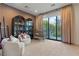 Bright bedroom featuring armchairs, bookshelf cabinets and a view of backyard playhouse at 3452 Spanish Winds Ct, Las Vegas, NV 89141