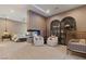 Large bedroom with arched cabinets, a crib, and fireplace feature at 3452 Spanish Winds Ct, Las Vegas, NV 89141