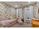 Cozy bedroom with floral wallpaper, daybed, sitting chair and white window curtains at 3452 Spanish Winds Ct, Las Vegas, NV 89141