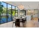 Bright dining area with modern lighting, an adjacent kitchen, and floor to ceiling windows at 3452 Spanish Winds Ct, Las Vegas, NV 89141