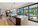 Bright kitchen with marble counters, stainless steel appliances, and a sliding glass door leading to the backyard at 3452 Spanish Winds Ct, Las Vegas, NV 89141
