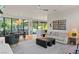 Open-concept living room with modern décor and a view of the backyard at 3452 Spanish Winds Ct, Las Vegas, NV 89141