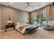 Relaxing main bedroom featuring patterned wallpaper, neutral colors, and comfortable seating at 3452 Spanish Winds Ct, Las Vegas, NV 89141