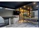 Covered patio with outdoor kitchen, dining area, and modern fixtures at 3452 Spanish Winds Ct, Las Vegas, NV 89141