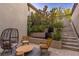 Relaxing outdoor patio showcases lush landscaping, a water feature, and comfortable seating area with shade at 3452 Spanish Winds Ct, Las Vegas, NV 89141