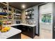 Walk-in pantry boasting custom shelving, dark cabinetry and a white countertop at 3452 Spanish Winds Ct, Las Vegas, NV 89141