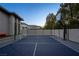 Private sport court with basketball hoop and tennis net, ideal for recreational activities at 3452 Spanish Winds Ct, Las Vegas, NV 89141