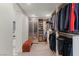Large walk-in closet with wood shelving, cabinets, a bench, and hanging space for coats and suits at 3452 Spanish Winds Ct, Las Vegas, NV 89141
