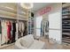 Luxurious walk-in closet features custom shelving, a chandelier, and a comfortable seating area at 3452 Spanish Winds Ct, Las Vegas, NV 89141
