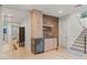 Indoor bar with a beverage fridge, wooden cabinets, stone countertop, and decorative tile backsplash at 3452 Spanish Winds Ct, Las Vegas, NV 89141