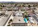 Aerial view of a residential property with a pool, landscaping, and a quiet neighborhood setting at 3649 Maria St, Las Vegas, NV 89121