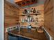 Custom-built bar area featuring wood paneling, open shelving, and a rustic wood countertop at 3717 Moonshine Falls Ave, North Las Vegas, NV 89085