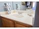 Bathroom vanity featuring a white countertop with chrome fixtures, and wood cabinets with modern decor at 3717 Moonshine Falls Ave, North Las Vegas, NV 89085