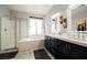 Bright bathroom featuring dual sinks, a soaking tub, and a walk-in shower at 3717 Moonshine Falls Ave, North Las Vegas, NV 89085