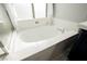 Elegant bathroom showcases a large soaking tub under a bright, frosted window at 3717 Moonshine Falls Ave, North Las Vegas, NV 89085