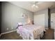 This bedroom features a ceiling fan, light gray walls, a window and closet at 3717 Moonshine Falls Ave, North Las Vegas, NV 89085
