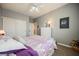 This bedroom has a ceiling fan, light gray walls, closet and a chest of drawers at 3717 Moonshine Falls Ave, North Las Vegas, NV 89085