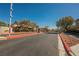 Inviting view of the community gate with well-maintained landscaping at 3717 Moonshine Falls Ave, North Las Vegas, NV 89085