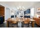 Bright dining room with stylish chandelier in open concept floorplan with bar and kitchen at 3717 Moonshine Falls Ave, North Las Vegas, NV 89085