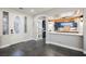 Inviting foyer with decorative door, stone floors, and views into a kitchen with counter seating at 3717 Moonshine Falls Ave, North Las Vegas, NV 89085