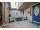 Charming front porch with comfortable seating and a stylish blue door, creating a welcoming entrance at 3717 Moonshine Falls Ave, North Las Vegas, NV 89085