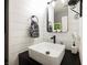 Modern half bathroom featuring shiplap wall, vessel sink, and sleek black hardware at 3717 Moonshine Falls Ave, North Las Vegas, NV 89085