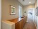 Hallway features a built-in cabinet with wooden countertop and view to a bedroom through an open door at 3717 Moonshine Falls Ave, North Las Vegas, NV 89085