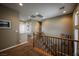 Upstairs hallway with plush carpeting, wooden and iron railing, and neutral paint at 3717 Moonshine Falls Ave, North Las Vegas, NV 89085