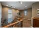 Upstairs hallway with plush carpeting, and wooden and iron railing at 3717 Moonshine Falls Ave, North Las Vegas, NV 89085