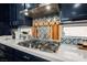 Modern kitchen with gas range and stainless steel hood and stylish tile backsplash at 3717 Moonshine Falls Ave, North Las Vegas, NV 89085