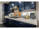 Modern kitchen with stainless steel hood over gas range and a stylish tile backsplash at 3717 Moonshine Falls Ave, North Las Vegas, NV 89085