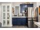 Eat-in kitchen featuring navy cabinets, stainless steel refrigerator, pantry, and coffee bar at 3717 Moonshine Falls Ave, North Las Vegas, NV 89085