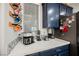 Coffee bar showcasing white marble counters, navy cabinets, and mug rack at 3717 Moonshine Falls Ave, North Las Vegas, NV 89085