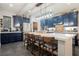 Modern kitchen with large island, stainless steel appliances, and stylish dark blue cabinets at 3717 Moonshine Falls Ave, North Las Vegas, NV 89085
