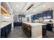 Spacious kitchen island offers seating with stylish chairs, and modern lighting fixtures at 3717 Moonshine Falls Ave, North Las Vegas, NV 89085