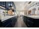 Galley kitchen featuring navy cabinets, white counters, stainless appliances, and an open design into the dining room at 3717 Moonshine Falls Ave, North Las Vegas, NV 89085
