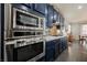 Gourmet kitchen with stainless steel appliances and stylish cabinets seamlessly connects to the dining room at 3717 Moonshine Falls Ave, North Las Vegas, NV 89085