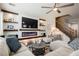 Comfortable living room features a fireplace, built-in shelves, ceiling fan and inviting seating area at 3717 Moonshine Falls Ave, North Las Vegas, NV 89085