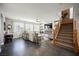 Bright living room boasts a ceiling fan, a cozy sofa, and a staircase with wood and iron accents at 3717 Moonshine Falls Ave, North Las Vegas, NV 89085