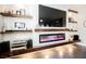 Living room featuring a cozy fireplace with built-in shelves, and modern entertainment center at 3717 Moonshine Falls Ave, North Las Vegas, NV 89085