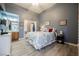 Comfortable main bedroom with wood-look floors and a conveniently located en-suite bathroom at 3717 Moonshine Falls Ave, North Las Vegas, NV 89085