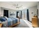 Bright main bedroom featuring a ceiling fan, carpet floors, and a sliding glass door to the outside at 3717 Moonshine Falls Ave, North Las Vegas, NV 89085