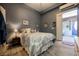 Comfortable bedroom with en-suite bathroom, and sliding doors opening onto front porch at 3717 Moonshine Falls Ave, North Las Vegas, NV 89085